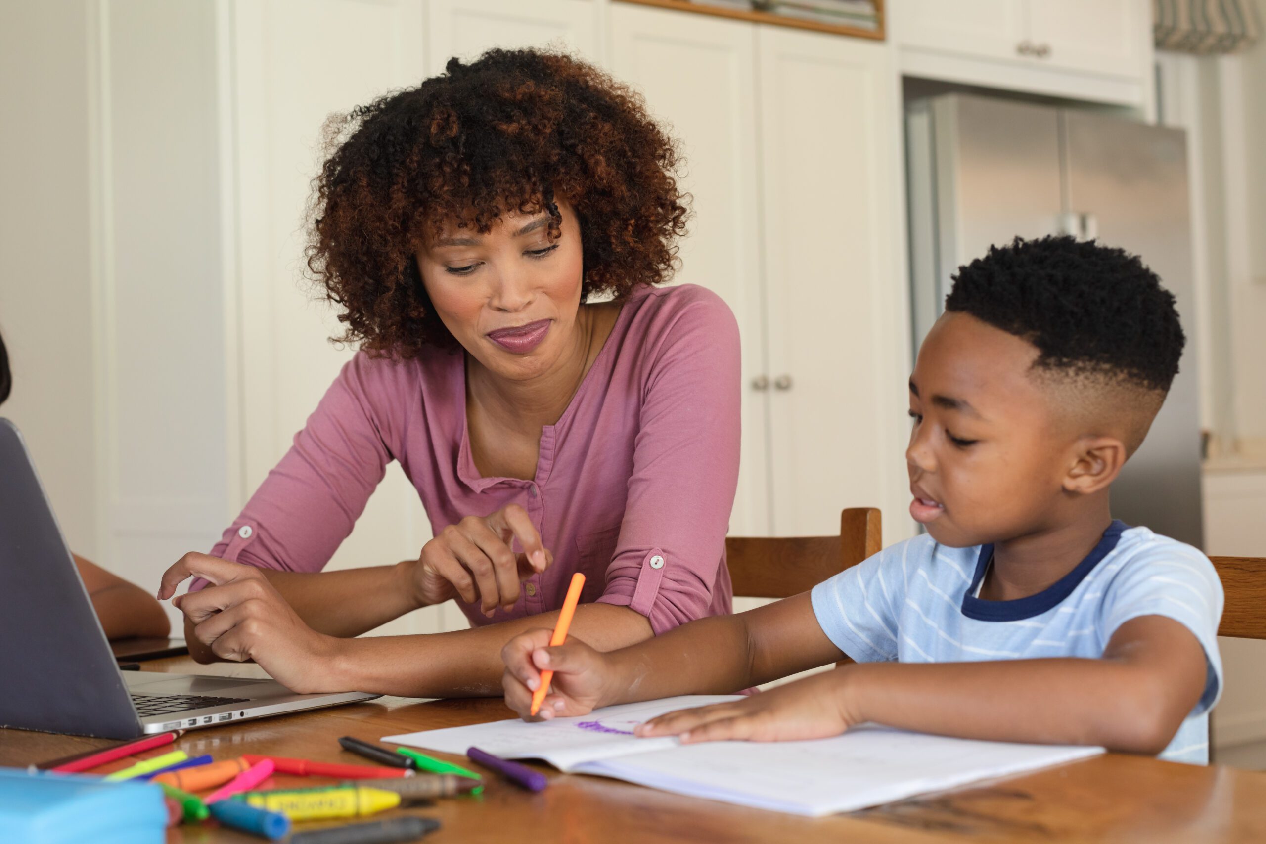 Woman and child learning together at home