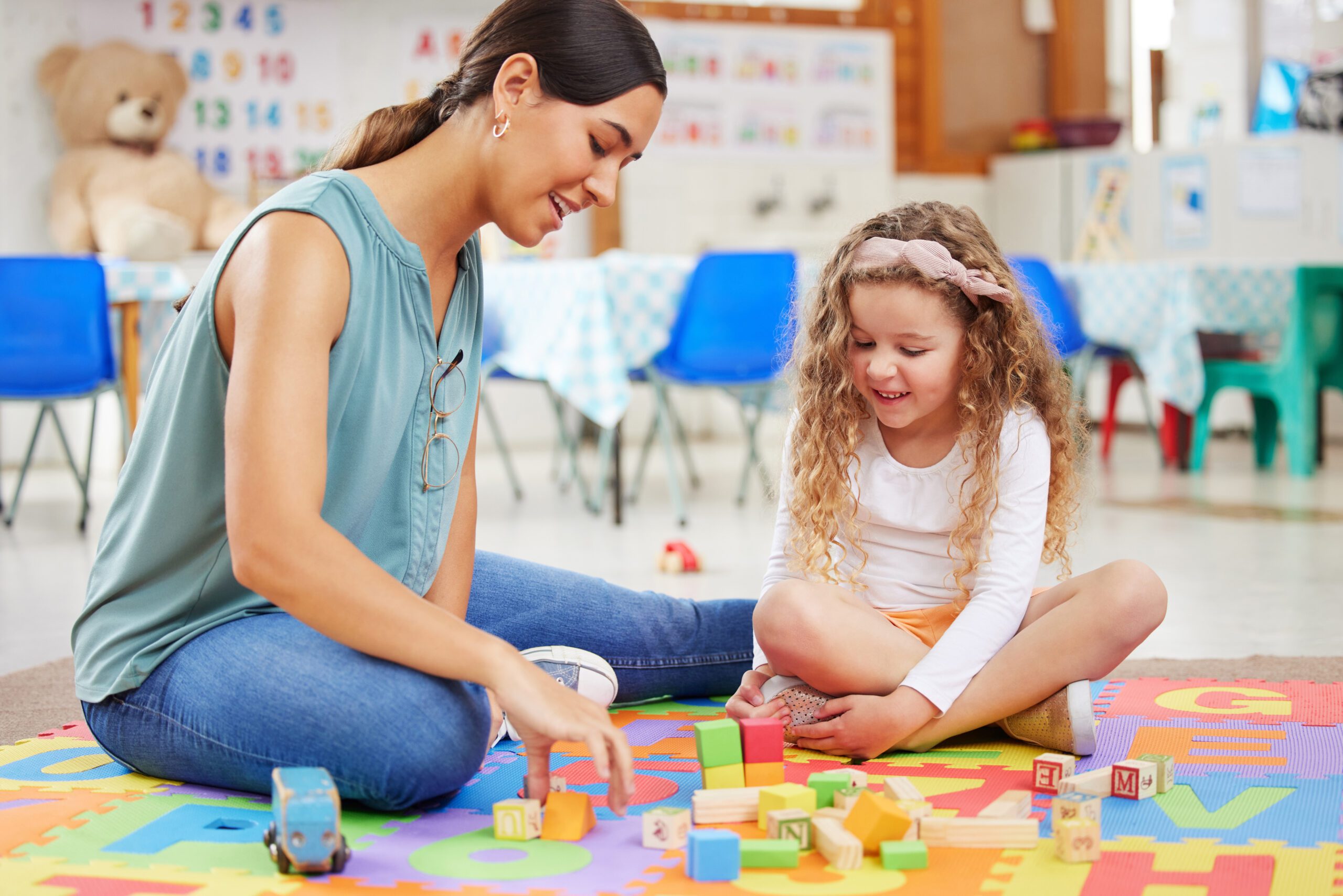 enthusiastic-woman-playing-with-girl-and-toy-block-2026-01-09-09-49-44-utc